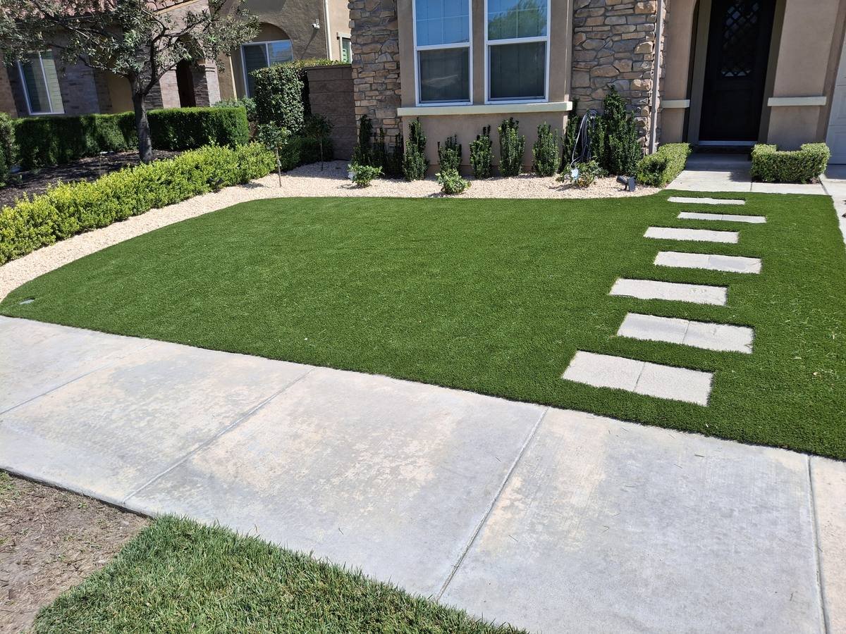 Front yard with stepping pads to the door, installed by Synthetic Grass Techs in Chino Hills