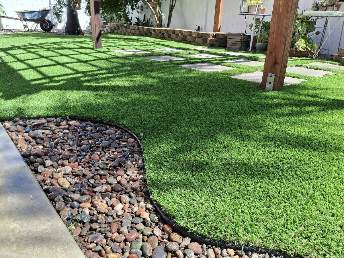 Evo 2 artificial grass: Backyard under a pergola, with stepping pads, installed by Synthetic Grass Techs in Moreno Valley
