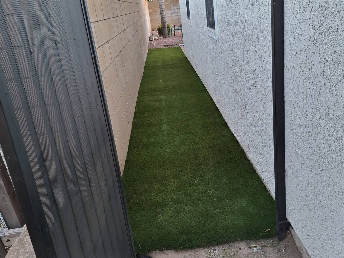 Side yard turf along the block wall, installed by Synthetic Grass Techs in San Bernardino