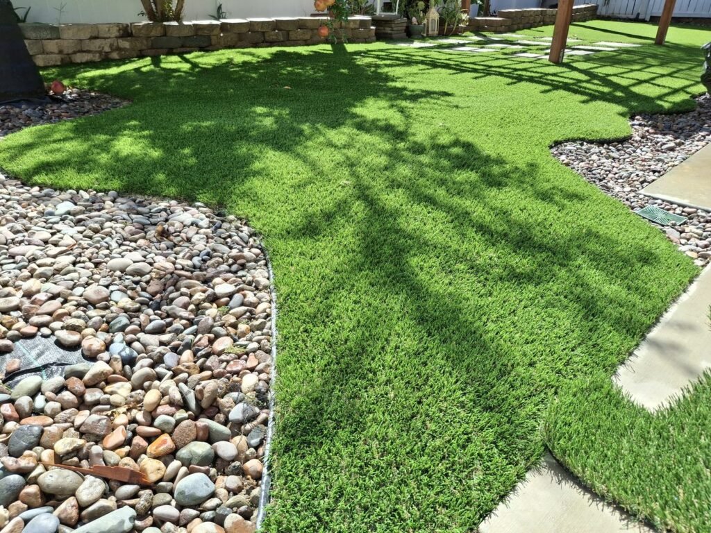 Artificial grass with stepping pads and a river rock border