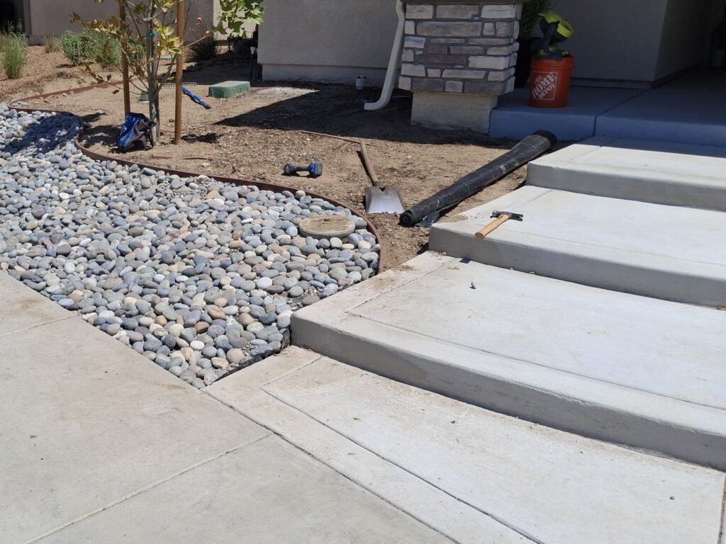 Front yard before turf, with the river rock bed finished
