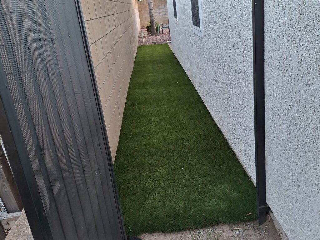 Narrow side yard with new artificial grass