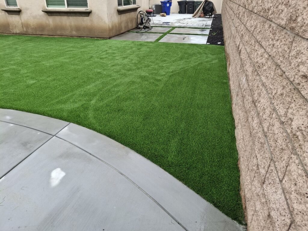Side yard artificial grass along a block wall